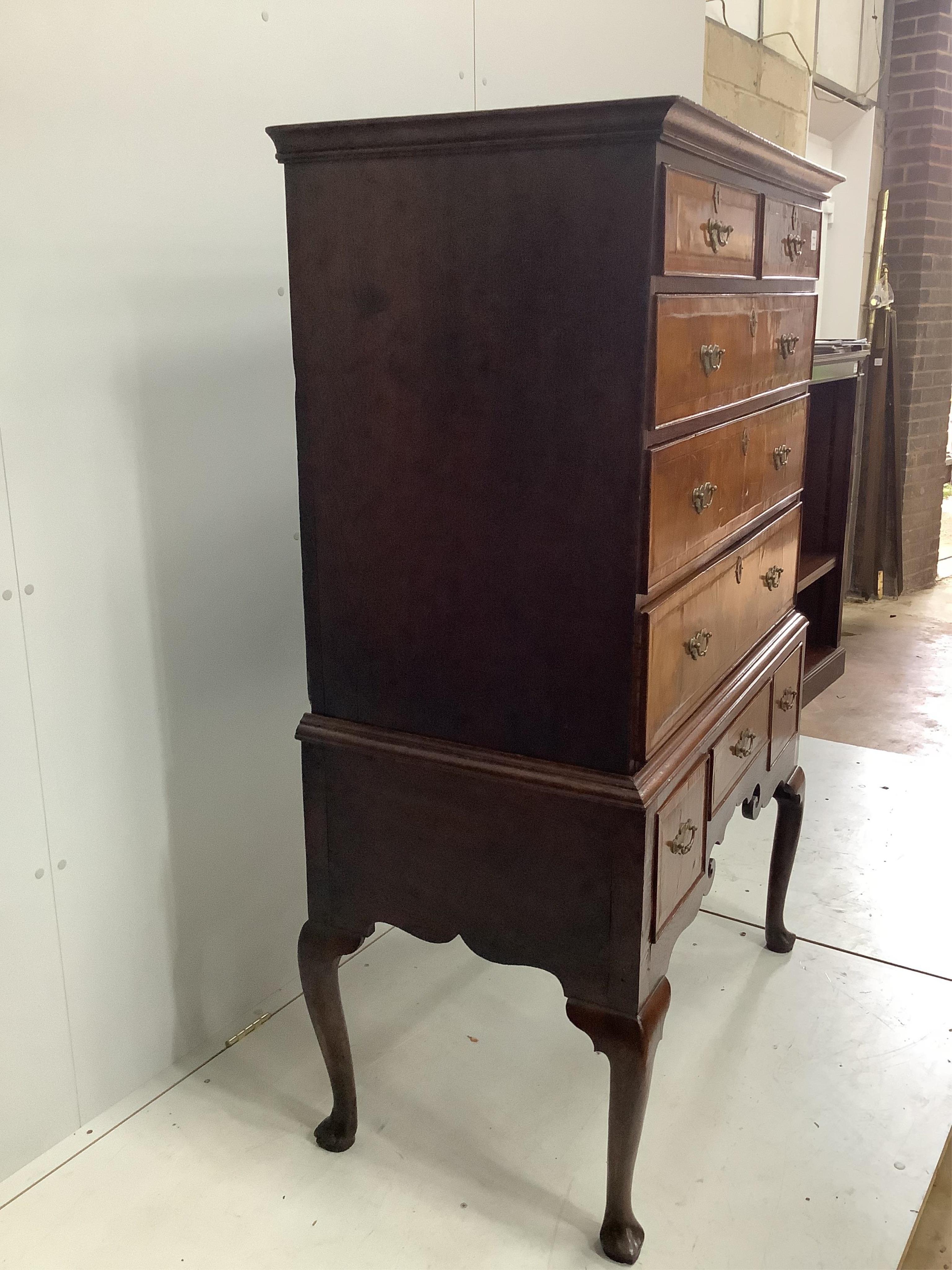 An 18th century banded walnut chest on stand, width 97cm, depth 53cm, height 152cm. Condition - fair